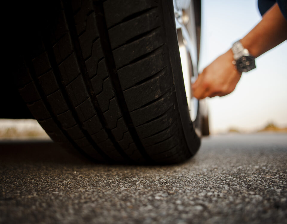 man checking tyre and doing tyre valve replacement