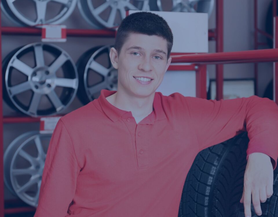 A-young-mechanic-with-car-tire-at-the-Best-tyre shop Manchester