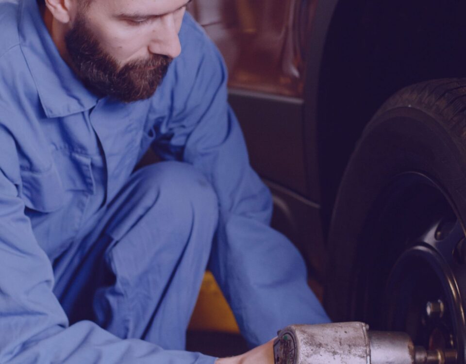 A-mechanic-at-Emergency-Mobile-tyre-services-Altrincham-Manchester-fixing-car-tyre-Emergency Mobile Tyre Services