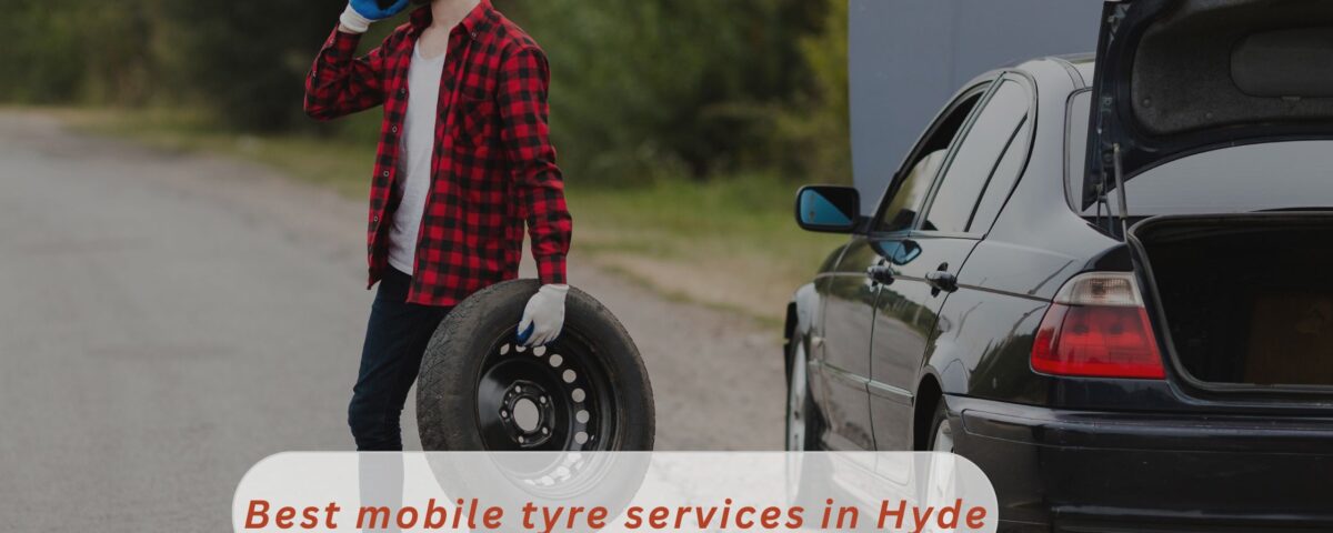 A Handsome guy is busy on phone holding a tyre calling a local mobile tyre services in Hyde