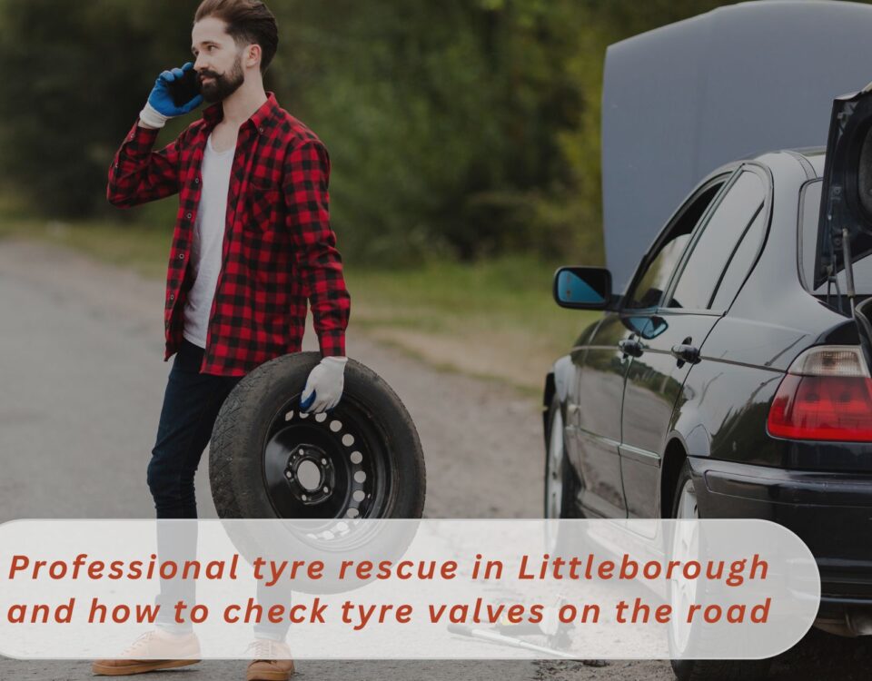 A tyre mechanic busy on phone holding a new tyre in his hand for dmtyres Professional tyre rescue in Littleborough